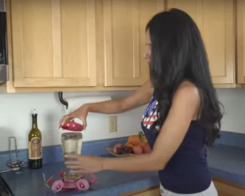 A girl replacing the hummingbird nectar